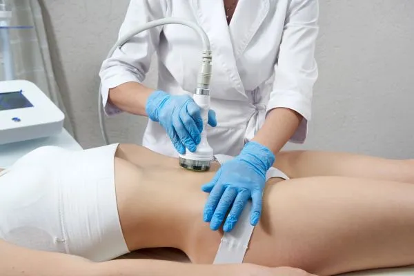Lost the Weight but Not the Loose Skin? 2 woman having HIFU treatment on her stomach to combat loose skin Stirling following weight loss